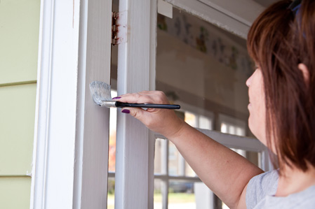 women-painting-door